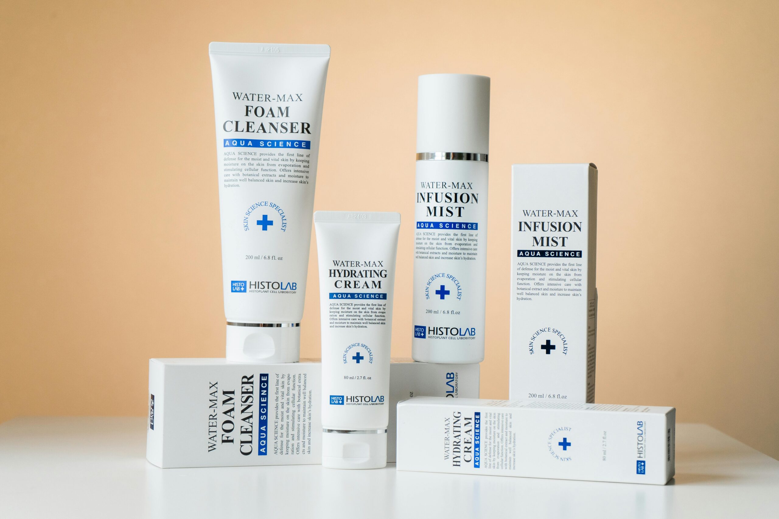 Elegant showcase of Water-Max skincare products including cleanser, cream, and mist on a white surface.